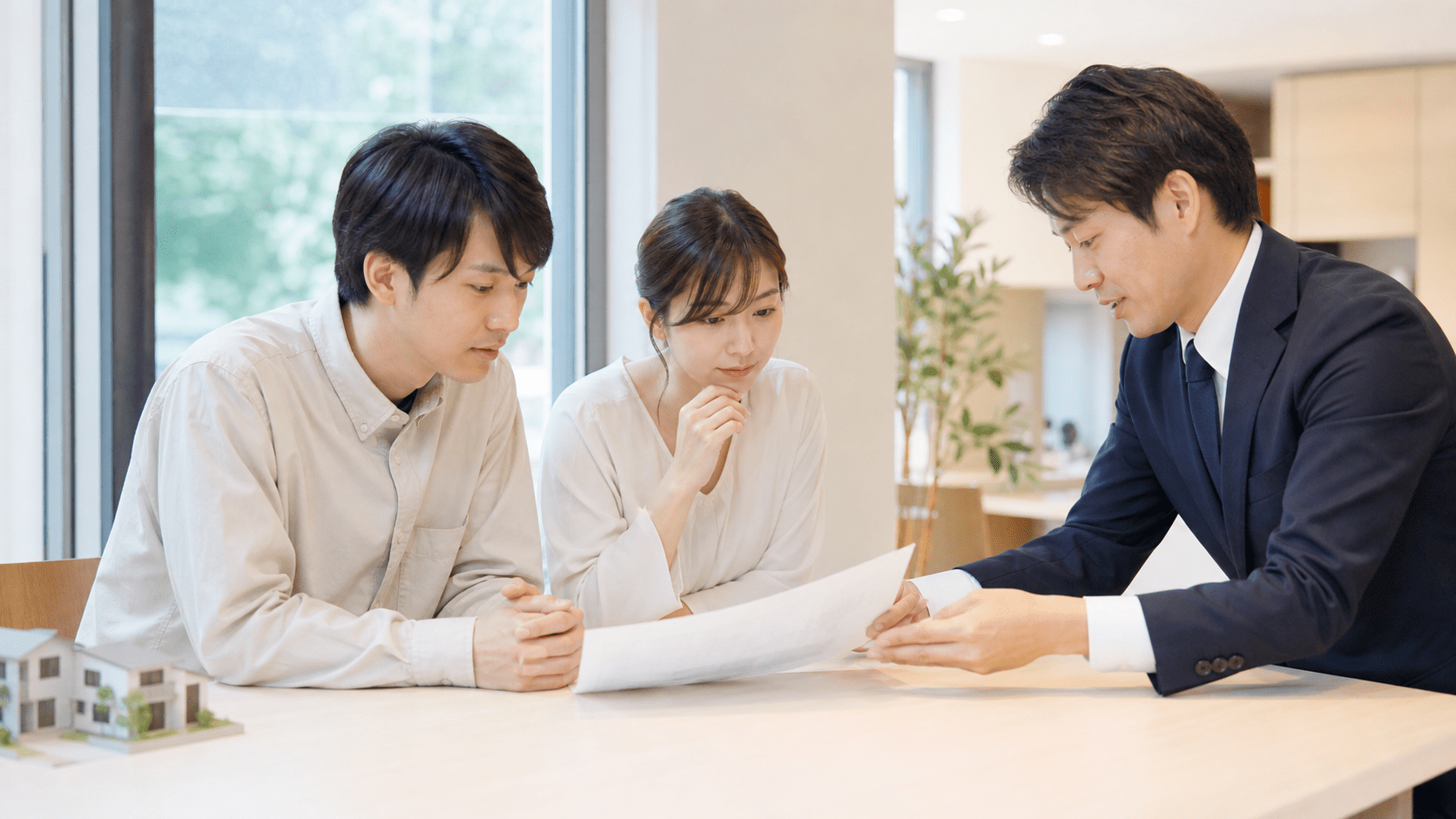 担当者と一緒に書類を確認する夫婦